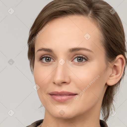 Joyful white young-adult female with medium  brown hair and grey eyes