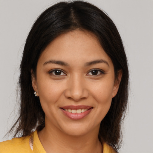 Joyful latino young-adult female with medium  brown hair and brown eyes