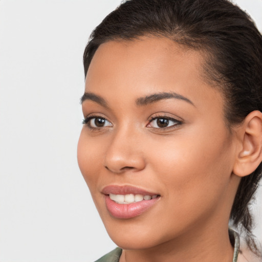 Joyful latino young-adult female with medium  brown hair and brown eyes