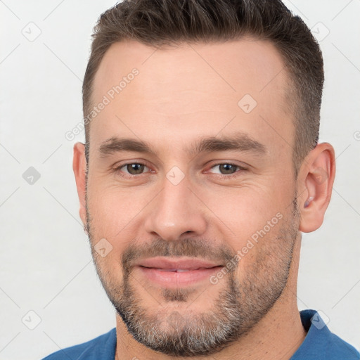 Joyful white young-adult male with short  brown hair and brown eyes