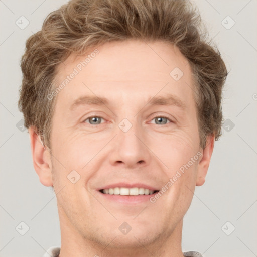 Joyful white adult male with short  brown hair and grey eyes