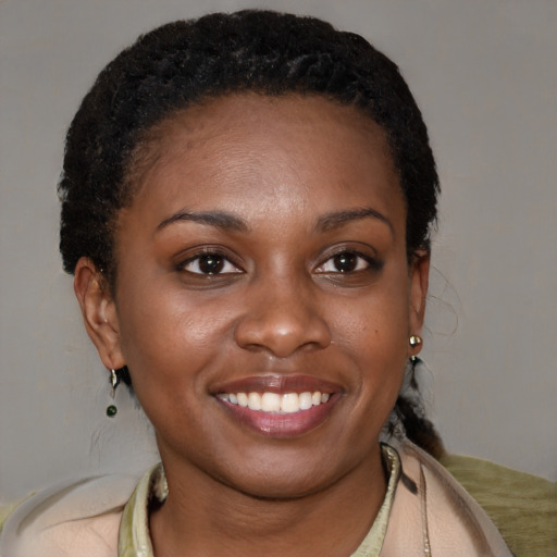 Joyful black young-adult female with short  brown hair and brown eyes