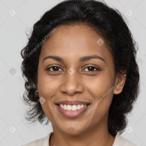 Joyful black young-adult female with long  brown hair and brown eyes