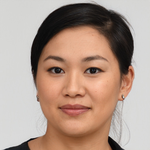 Joyful asian young-adult female with medium  black hair and brown eyes
