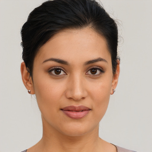 Joyful latino young-adult female with medium  brown hair and brown eyes