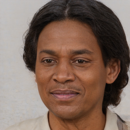 Joyful latino adult male with medium  brown hair and brown eyes