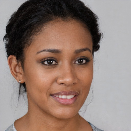 Joyful latino young-adult female with short  brown hair and brown eyes