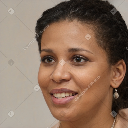 Joyful black young-adult female with long  brown hair and brown eyes