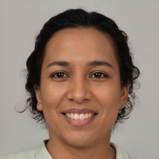 Joyful latino young-adult female with medium  brown hair and brown eyes