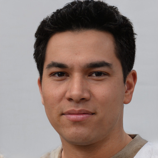 Joyful white young-adult male with short  black hair and brown eyes