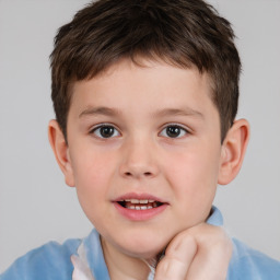 Joyful white child male with short  brown hair and brown eyes