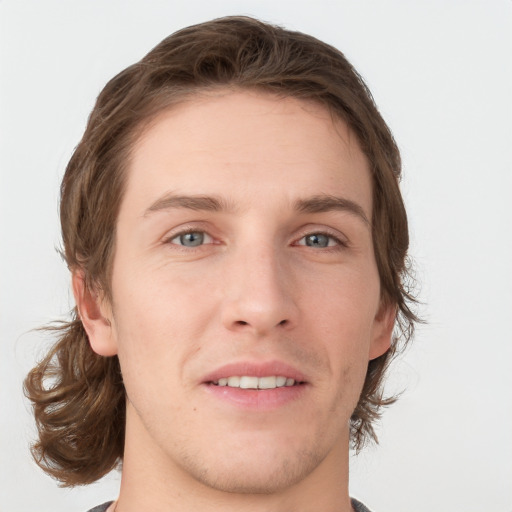 Joyful white young-adult male with medium  brown hair and grey eyes