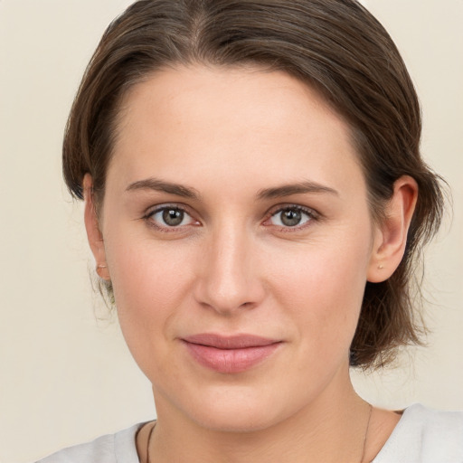 Joyful white young-adult female with medium  brown hair and brown eyes