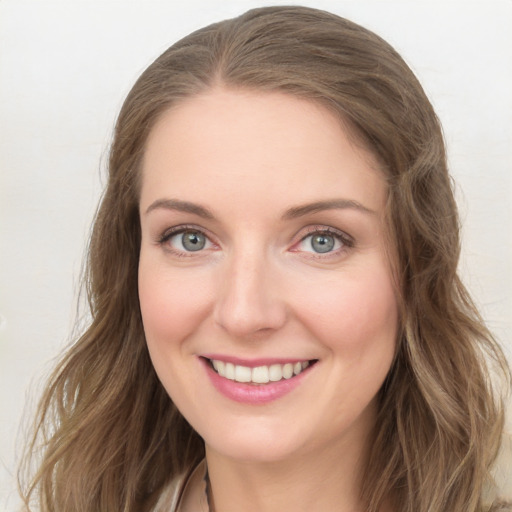 Joyful white young-adult female with long  brown hair and blue eyes