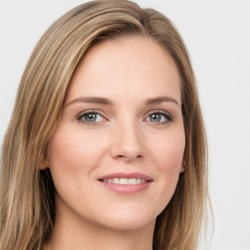 Joyful white young-adult female with long  brown hair and grey eyes