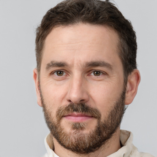 Joyful white adult male with short  brown hair and brown eyes