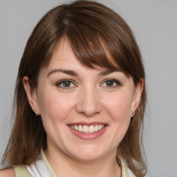 Joyful white young-adult female with medium  brown hair and blue eyes