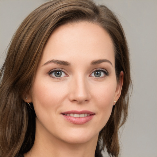 Joyful white young-adult female with long  brown hair and grey eyes