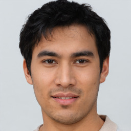 Joyful asian young-adult male with short  black hair and brown eyes