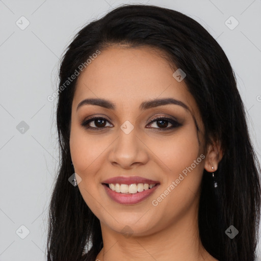 Joyful latino young-adult female with long  black hair and brown eyes