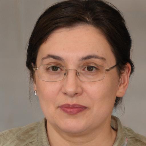 Joyful white adult female with medium  brown hair and brown eyes