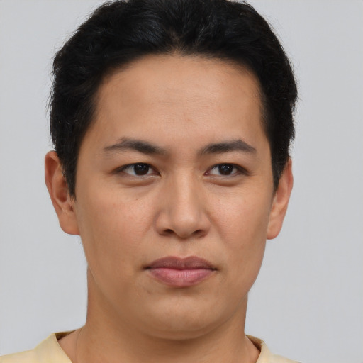 Joyful asian young-adult male with short  brown hair and brown eyes