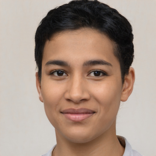 Joyful latino young-adult female with short  black hair and brown eyes