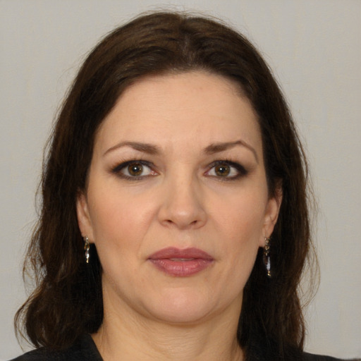 Joyful white adult female with medium  brown hair and brown eyes