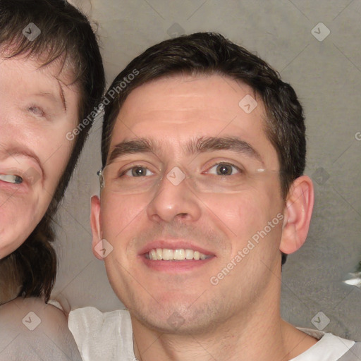 Joyful white adult male with short  brown hair and grey eyes