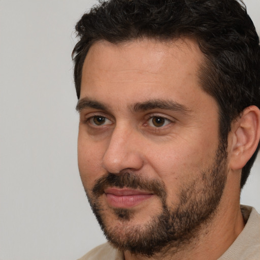 Joyful white adult male with short  brown hair and brown eyes