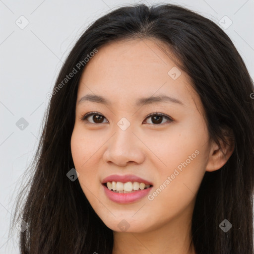 Joyful asian young-adult female with long  brown hair and brown eyes