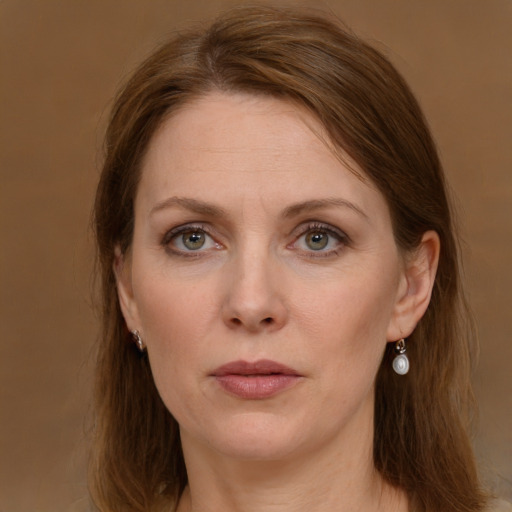 Joyful white adult female with long  brown hair and green eyes