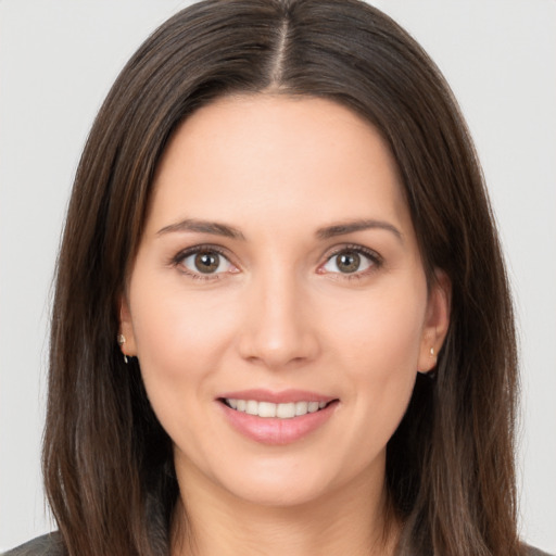 Joyful white young-adult female with long  brown hair and brown eyes