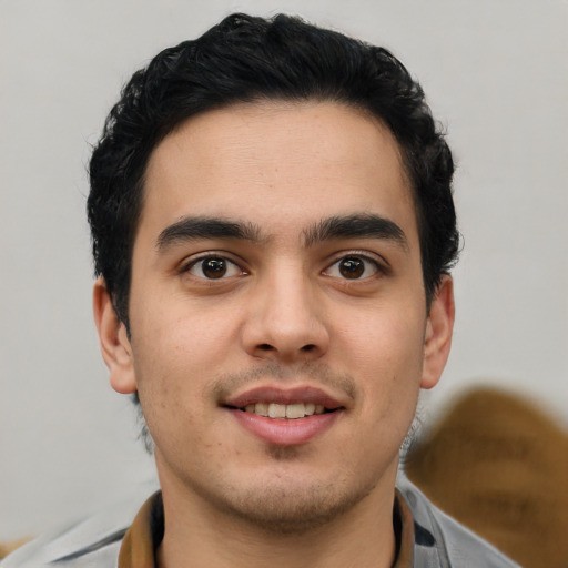 Joyful latino young-adult male with short  brown hair and brown eyes