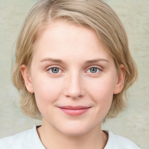 Joyful white young-adult female with medium  brown hair and blue eyes