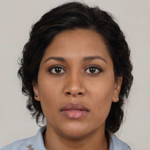Neutral latino young-adult female with medium  brown hair and brown eyes