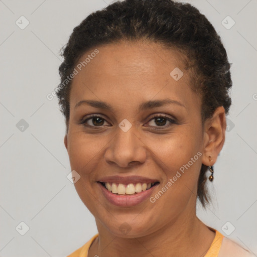 Joyful black young-adult female with short  brown hair and brown eyes