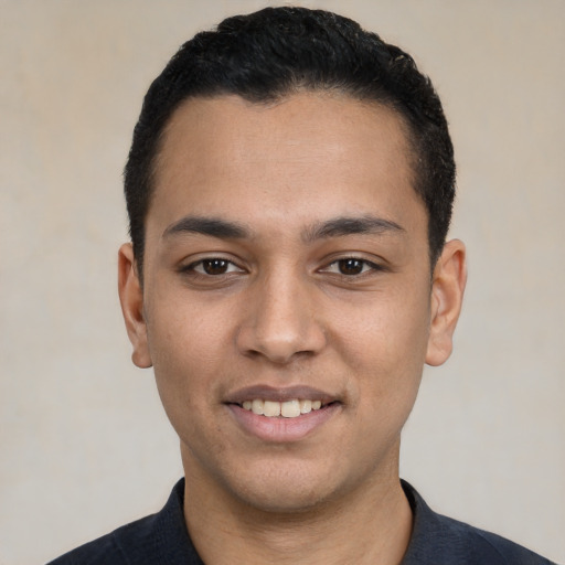 Joyful white young-adult male with short  black hair and brown eyes