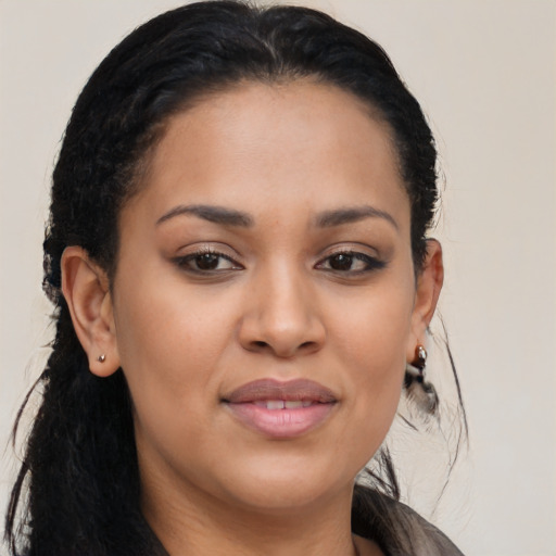 Joyful black young-adult female with long  brown hair and brown eyes