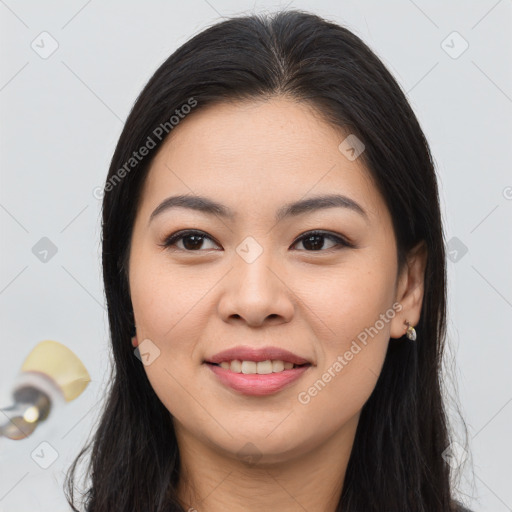 Joyful asian young-adult female with long  brown hair and brown eyes