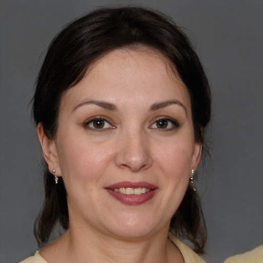 Joyful white young-adult female with medium  brown hair and brown eyes