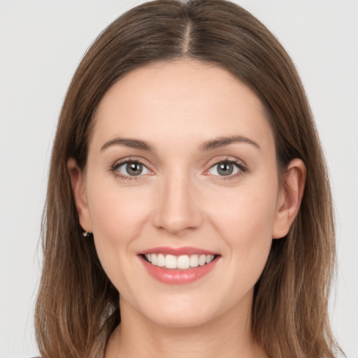 Joyful white young-adult female with long  brown hair and grey eyes