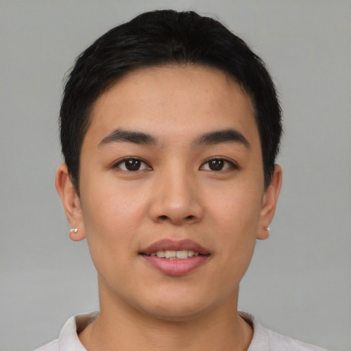 Joyful asian young-adult male with short  brown hair and brown eyes