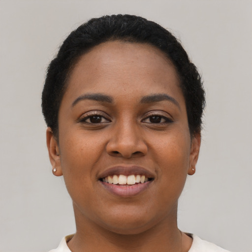 Joyful latino young-adult female with short  black hair and brown eyes