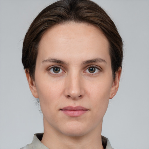 Joyful white young-adult female with short  brown hair and brown eyes