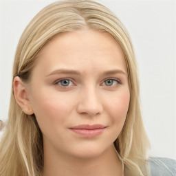 Joyful white young-adult female with long  brown hair and blue eyes