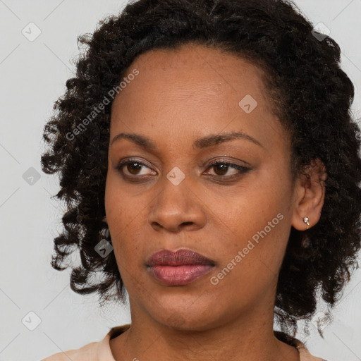 Joyful black young-adult female with medium  brown hair and brown eyes