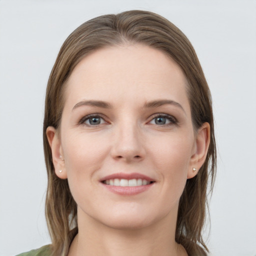 Joyful white young-adult female with long  brown hair and grey eyes