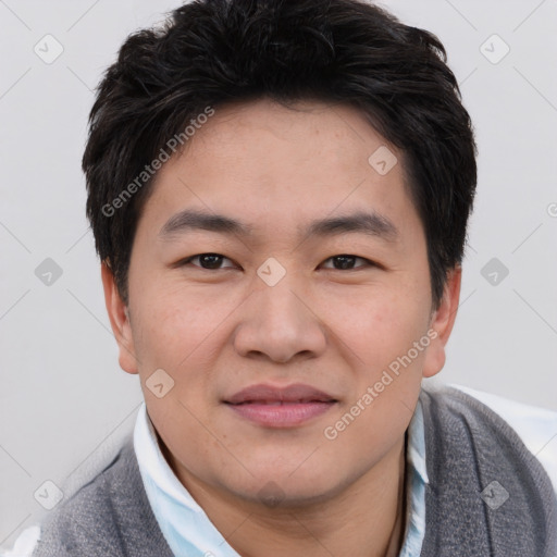 Joyful asian young-adult male with short  black hair and brown eyes