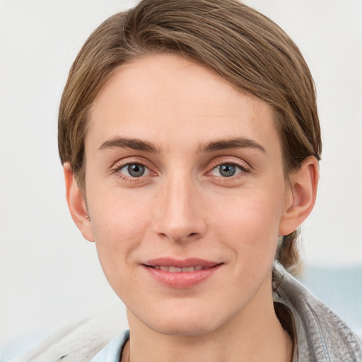 Joyful white young-adult female with short  brown hair and grey eyes